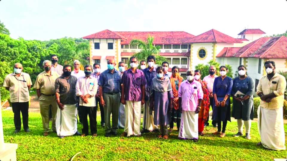 Some India Bible College and Seminary staff (on the left) with part of the COVID medical staff. Main classroom and administration building in the background.