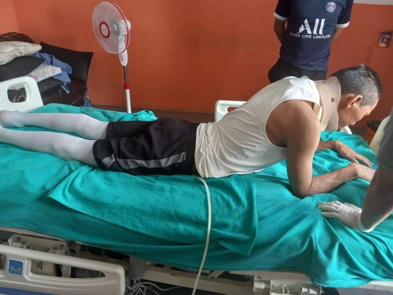 Evangelist Phendey, after the accident, and during his daily bed therapy.